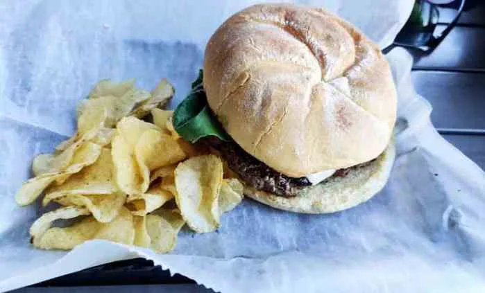 Classic burger with chips on the deck